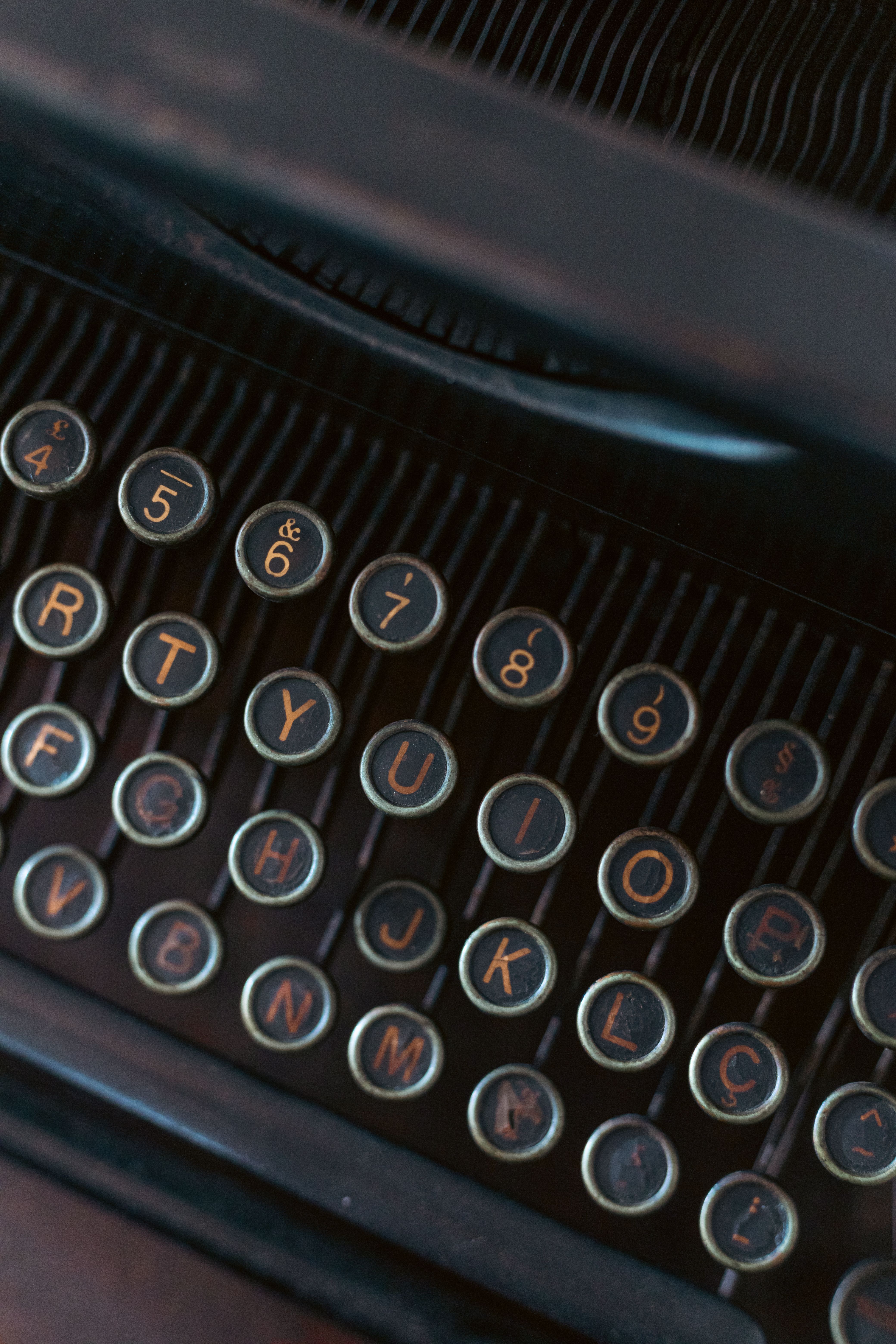 Focused shot of antique typewriter keys displaying letters and numbers.
