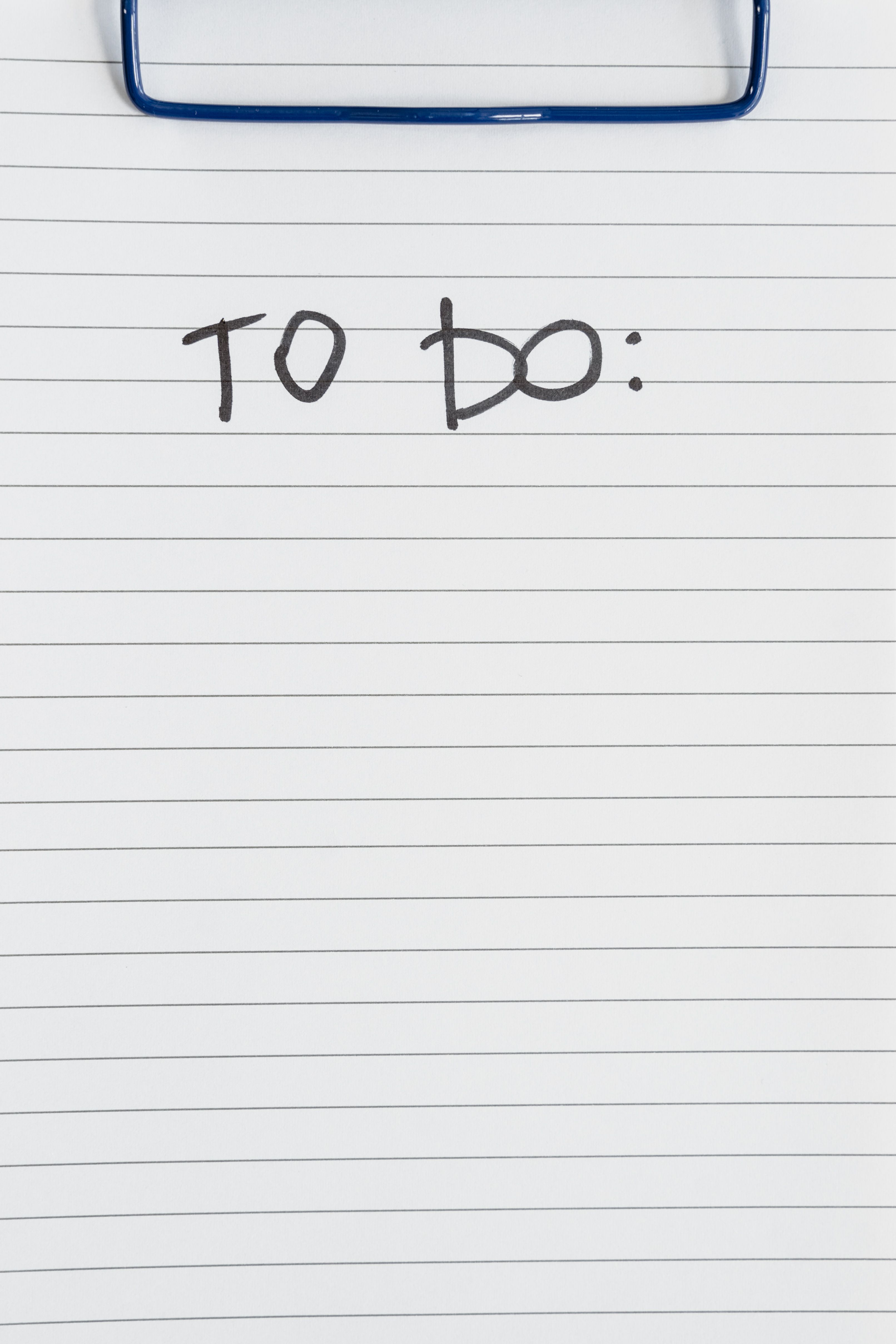 A close-up of a lined paper with 'TO DO' text at the top, ideal for listing tasks.